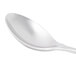 A Libbey stainless steel dessert spoon with a white handle.