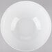 A Tablecraft Sierra white melamine bowl with a curved edge on a gray background.