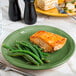 A Libbey sage green porcelain plate with cooked salmon and green beans.