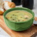 A close up of a bowl of soup in a green Libbey porcelain bowl.