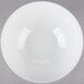 A Tablecraft white melamine bowl with a white rim on a gray background.
