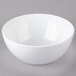 A white Tablecraft Sierra melamine bowl on a gray surface.