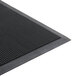 A close-up of a black rubber Cactus Mat with holes in it.