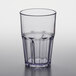 A close up of a clear plastic tumbler with a black rim.