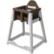 A brown and white Koala Kare high chair.