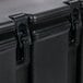 A close up of a black Cambro soup carrier with a white stripe.