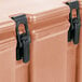 A close-up of a beige plastic Cambro soup carrier.