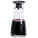 An Arcoroc glass carafe with a black liquid inside.