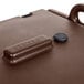 A brown plastic box with a black handle and lid.