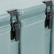 A close-up of a Cambro slate blue insulated soup carrier with black latches and a handle.