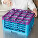 A person pouring liquid into a purple Carlisle glass rack with extenders.