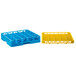 A yellow plastic Carlisle glass rack with blue and yellow compartments on a white background.