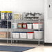 Regency stainless steel shelving in a school kitchen with containers on shelves.