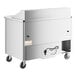 A large stainless steel refrigerated sandwich prep table with wheels.