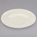 A white porcelain cup and saucer on a gray surface.