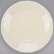 A white porcelain cup and saucer with a circular edge.