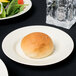 A 10 Strawberry Street Royal Cream porcelain bread and butter plate with food on it on a table.