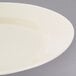 A close-up of a 10 Strawberry Street Royal Cream porcelain bread and butter plate with a white rim.