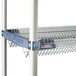 A stainless steel MetroMax iQ drop-in rack on a metal shelf.