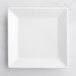 An Acopa bright white square porcelain plate on a white surface.