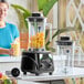 A commercial blender with toggle control and two 64 oz. Tritan containers.