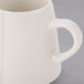 A Libbey Farmhouse ivory porcelain creamer with a handle.