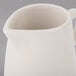 A Libbey Farmhouse ivory porcelain creamer with a handle.