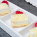 A Libbey white porcelain tray with four small desserts on it.