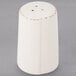 A Libbey ivory porcelain pepper shaker on a gray surface.