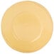 A close-up of a Libbey Farmhouse yellow porcelain plate with a wide rim.