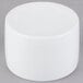 A white cylinder on a gray surface with a white Libbey Chef's Selection bowl inside.