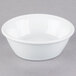 A white Libbey porcelain ramekin on a gray surface.