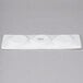 A white tray with three circles on it.