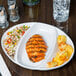 A Libbey Chef's Selection divided platter with food on a table.