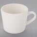 A white coffee cup with a handle.