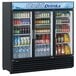 A Turbo Air three section glass door refrigerator full of drinks with a blue and white logo.