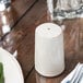 A plate with a Libbey Farmhouse ivory salt shaker on it.