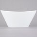 A Libbey ultra bright white porcelain Neptune bowl with a curved edge on a white background.