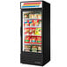 A black True glass door merchandiser freezer with food on the shelves.