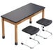 A black National Public Seating science lab table with a black chem-res top and metal legs with two black chairs.