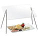 A Cal-Mil rectangular sneeze guard with a black iron wire frame over a plate of food.