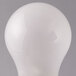 A close-up of a Satco frosted finish incandescent light bulb.