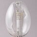 A clear Satco high pressure sodium light bulb with a metal base.