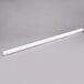 A white tube on a gray surface.