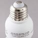 A close-up of a Satco warm white mini spiral compact fluorescent light bulb with a silver cap.