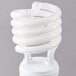A close up of a Satco spiral compact fluorescent light bulb.
