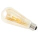 A Satco transparent amber LED light bulb with a filament.