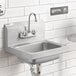 A Regency wall mounted hand sink with a gooseneck faucet over it.