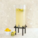A black Cal-Mil beverage dispenser with lemons in it.