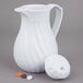 A white Vollrath SwirlServe hot and cold beverage server with a handle and cap.